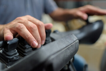 close up of hands directing a forklift