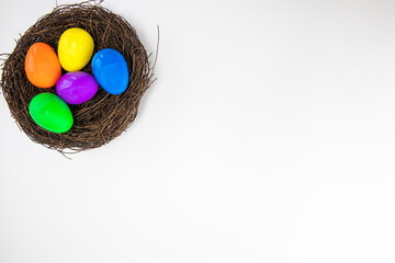 Colorful painted Easter Eggs isolated on white background with nest.Top view Happy Easter Holiday copy space