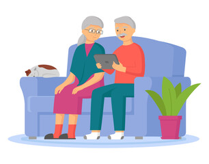 Pair of smiling elderly man and woman surfing internet together. Happy old couple watching video on tablet pc. Grandparents sitting with gadget in living room. Elderly people are using technologies