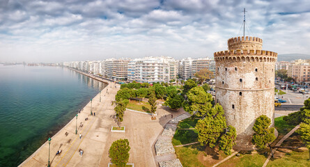 Aerial panoramic view of the main symbol of Thessaloniki city and the whole of Macedonia region - the White Tower. Concept of travel destinations in Greece and urban development. - obrazy, fototapety, plakaty