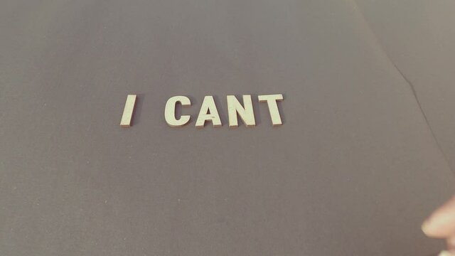 I Can&rsquo;t Negative thoughts &ndash; Human hand Adding the letter T to say I cant. disapproval, reluctance, unwillingness, hesitation, negative thinking, frustration to achieve results in business concept.