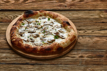 Appetizing pizza with mushrooms on a wooden tray