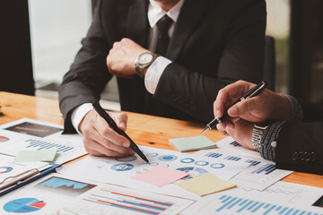 Businessman advisor, two business people talking, planning analyze investment and marketing on tablet in office.