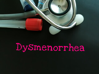 Dysmenorrhea word on blackboard with medical equipment.