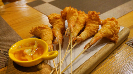 shrimp in tempura with sauce, food on the table in a cafe in a bar