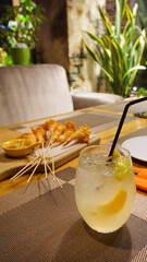 cocktail with lemon on the table in the cafe in the bar refreshing drink