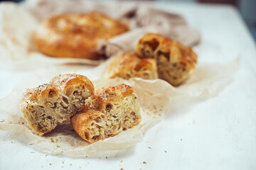 Homemade chicken puff pie, selective focus on a table on a light background