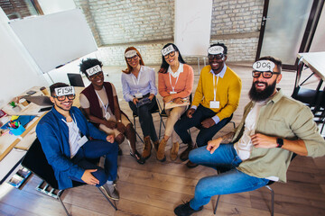 Team building. Happy colleagues playing who I am game, having great pastime together