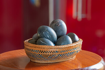 photo of eggs in a wicker basket, painted in a dark color. Easter theme
