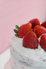 Obraz na płótnie Canvas A homemade strawberry cake on a black plate and marble worktop. Made with almond flour.