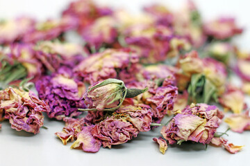 Dry rose buds tea on white background. Selektive focus.