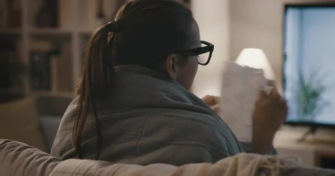 Woman with cold and flu watching TV
