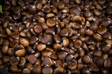 Organic fresh raw pile of chestnuts on sale