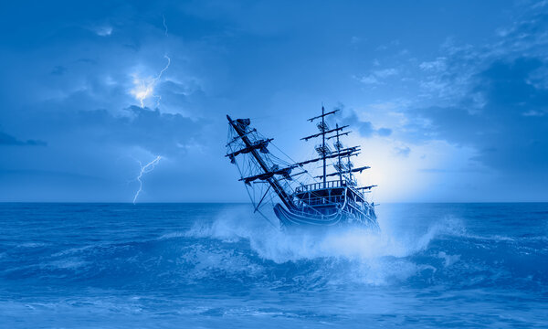 Sailing old ship in storm sea on the background heavy clouds with lightning