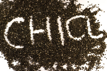 Chia seeds scattered on white background with text on it