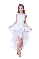Naklejka premium Happy beautiful little girl in white dress posing on white background