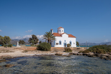 Fototapeta na wymiar Elafonisos Peloponnese. Greece. Agios Spyridon church at island port, sunny day, blue sky