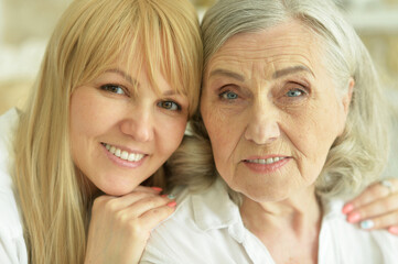 Portrait of senior woman with daughter at home