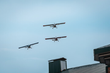 Three planes fly over the roof of the house. Airplanes in the sky.