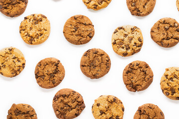 Fresh cookies with chocolate chips pattern on white background.