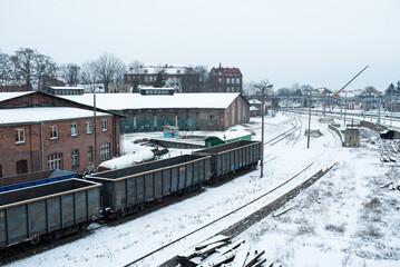 Carriages with coal in Tczew on the cargo rails in winter time.