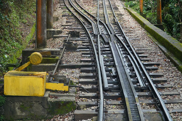 Track, rack and a switch with yellow lever on the famous rack railroad to Corcovado mountain in Rio de Janeiro, Brazil.