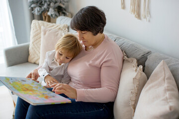 Grandmother and child, sitting at home on the sofa, hugging, pure love