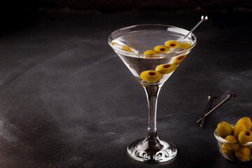 Martini cocktail on dark stone table.