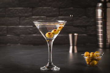 Martini cocktail on dark stone table.