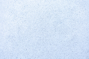 Natural pure white crystal fuzzy frozen ice covering the floor surface at cold weather after blizzard snow in winter season, top view. Abstract beauty texture background, cool nature concept.