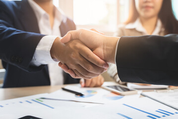 group of successful business people meeting. client and suppliers shaking hands after deal agreement completed.