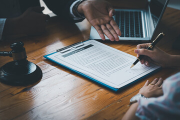 Fototapeta premium Female hand signing contract. Cropped shot of business people signing a contract at workplace