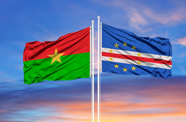 Burkina Faso and Cape Verde two flags on flagpoles and blue cloudy sky