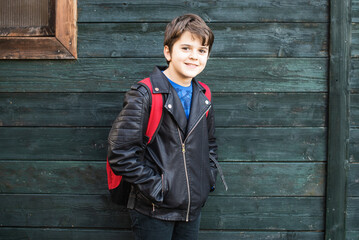 portrait of boy with backpack ready to go to school