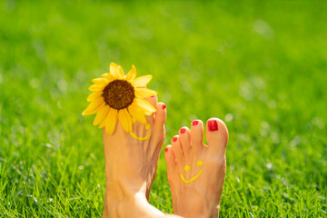 Happy woman with smile on feet outdoor in spring