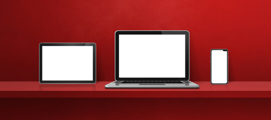 Laptop, mobile phone and digital tablet pc on red wall shelf. Banner background