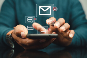 Businessman using smartphone to check email notification with icon or hologram. online communication technology concept
