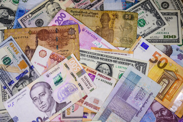 Multi currency background. Euro, american dollars, ukrainian hryvnias, egyptian pounds, russian roubles