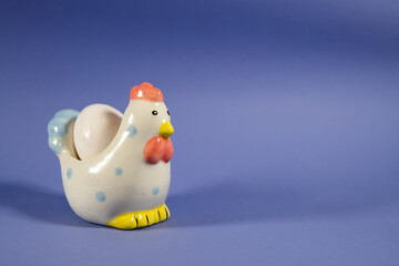 ceramic chicken on a purple background