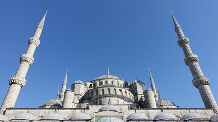 Fototapeta na wymiar Exterior view of a mosque reaching up into a blue sky