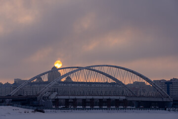 Sunset over the bridge across Ishim river in Nur-Sultan, Kazakhstan.