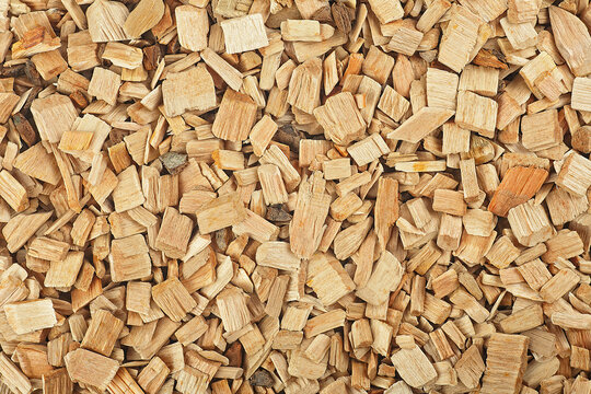 Wood smoking chips as background. Dry wood shavings background. Ecological fuel.