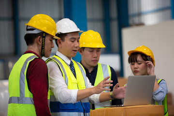  Warehouse worker meeting. Employee asian people using laptop in factory