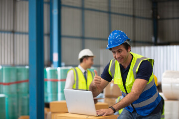  Warehouse worker online conference meeting. Employee asian people using laptop in factory