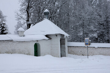 Svyatogorsky Monastery in Pushkin hills, Russia and snow covered trees