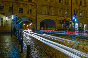 Blurred traffic, night streets and tunnels through buildings