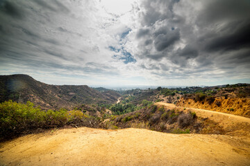 Dramatic sky over Bronson Canyon with Los Angeles on the background