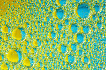 Psychedelic blueand yellow oil and water abstract background. Abstract colorful background. Foam of Soap with Bubbles macro shot. Closeup bubbles in water. Oil drops on a water surface blue and yellow
