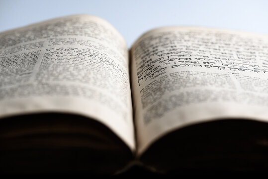 Open page of Torah. Closeup of old jewish holy book. Selective focus.