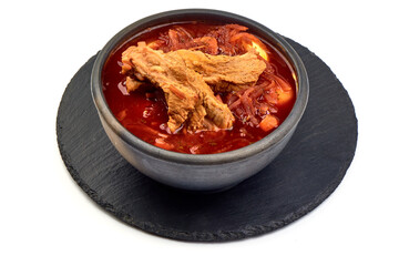 Traditional Ukrainian borscht with pork ribs, close-up, isolated on white background.